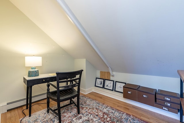 office area with baseboards, vaulted ceiling, and wood finished floors