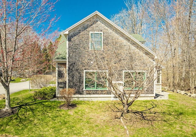 view of side of home with a lawn