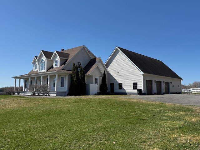 129 Williams Rd, Presque Isle, ME 04769 - view of home's exterior featuring driveway, a detached garage, covered porch, fence, and a yard
