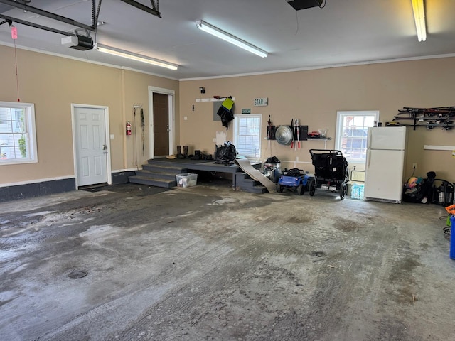 129 Williams Rd, Presque Isle, ME 04769 - garage featuring freestanding refrigerator and a garage door opener