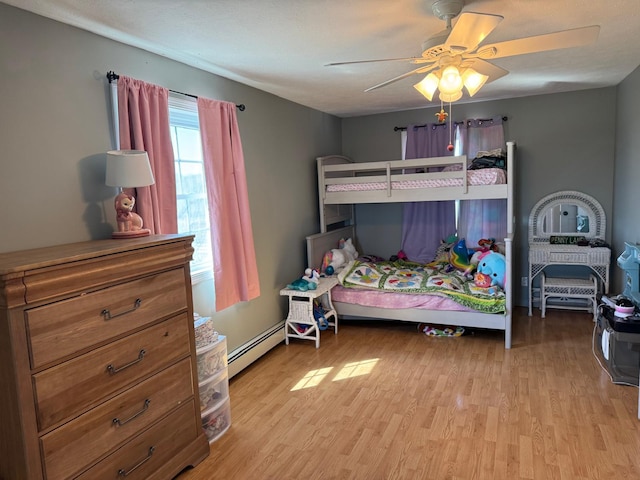 129 Williams Rd, Presque Isle, ME 04769 - bedroom featuring ceiling fan, baseboard heating, and wood finished floors