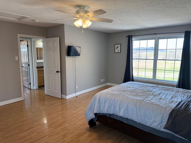 129 Williams Rd, Presque Isle, ME 04769 - bedroom featuring baseboards, ceiling fan, a textured ceiling, and light wood finished floors