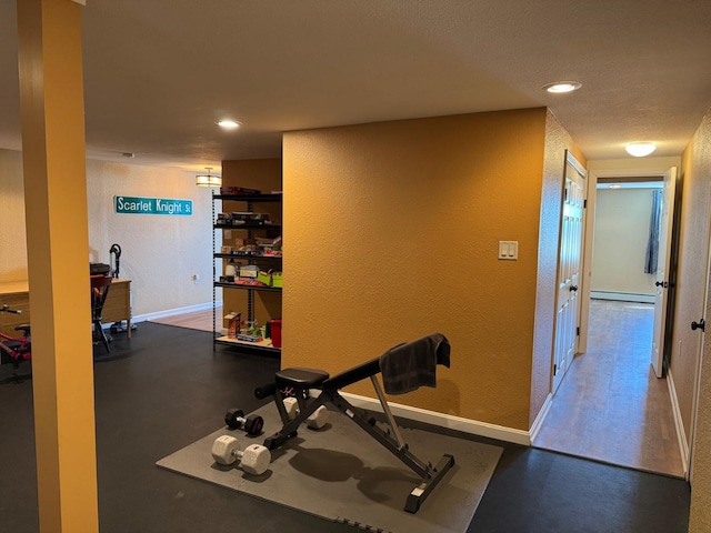 129 Williams Rd, Presque Isle, ME 04769 - exercise area with baseboards, recessed lighting, a textured wall, and a baseboard radiator