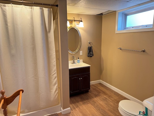 129 Williams Rd, Presque Isle, ME 04769 - bathroom with wood finished floors, a shower with shower curtain, toilet, vanity, and baseboards