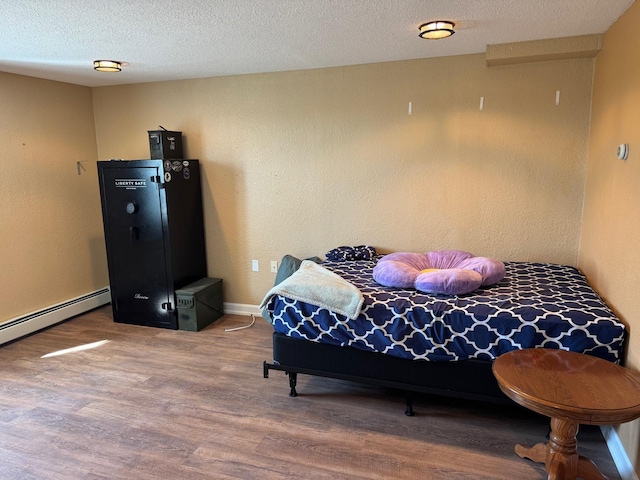 129 Williams Rd, Presque Isle, ME 04769 - bedroom with baseboards, wood finished floors, and a textured ceiling