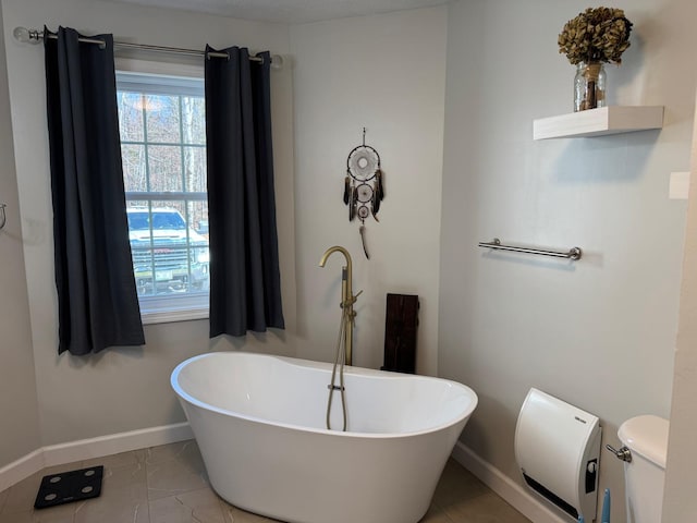 129 Williams Rd, Presque Isle, ME 04769 - full bath featuring baseboards, toilet, and a soaking tub