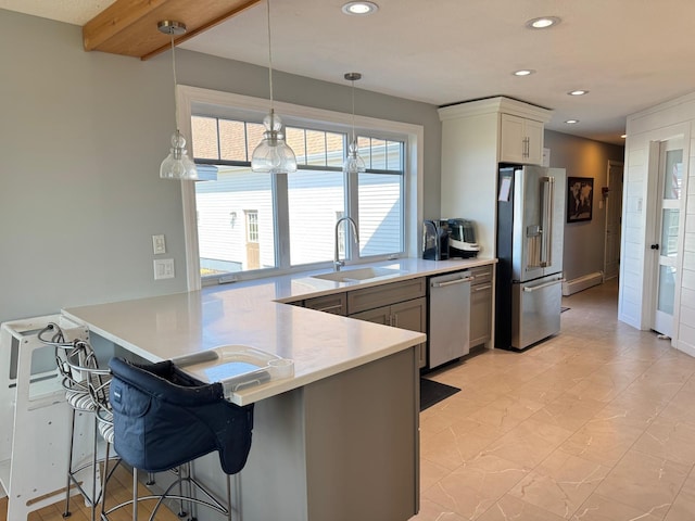 129 Williams Rd, Presque Isle, ME 04769 - kitchen featuring a kitchen breakfast bar, a sink, stainless steel appliances, light countertops, and a peninsula
