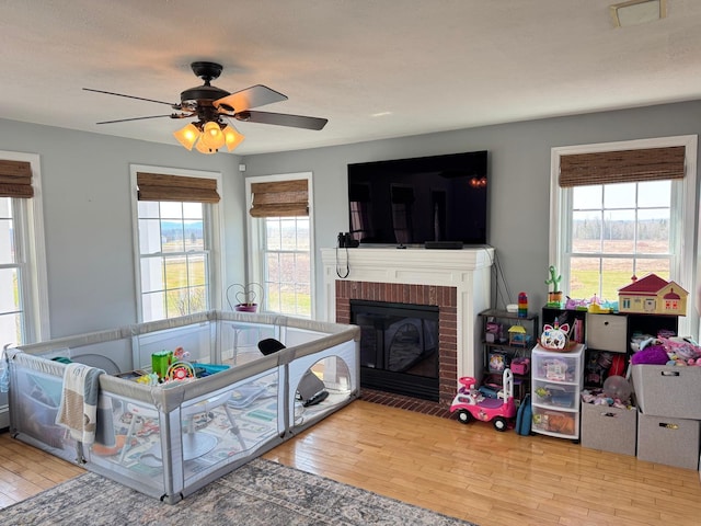 129 Williams Rd, Presque Isle, ME 04769 - recreation room with ceiling fan, wood finished floors, a healthy amount of sunlight, and a fireplace