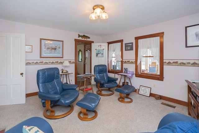 living area with carpet floors, baseboards, and visible vents