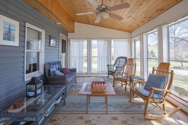 sunroom featuring a healthy amount of sunlight, wooden ceiling, ceiling fan, and lofted ceiling