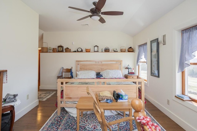 bedroom with visible vents, lofted ceiling, wood finished floors, baseboards, and a ceiling fan