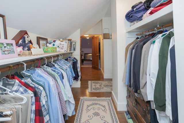 spacious closet with lofted ceiling and wood finished floors