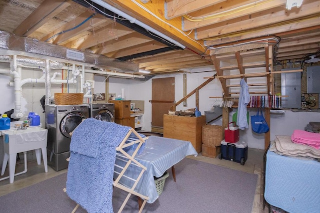 unfinished below grade area featuring washing machine and clothes dryer