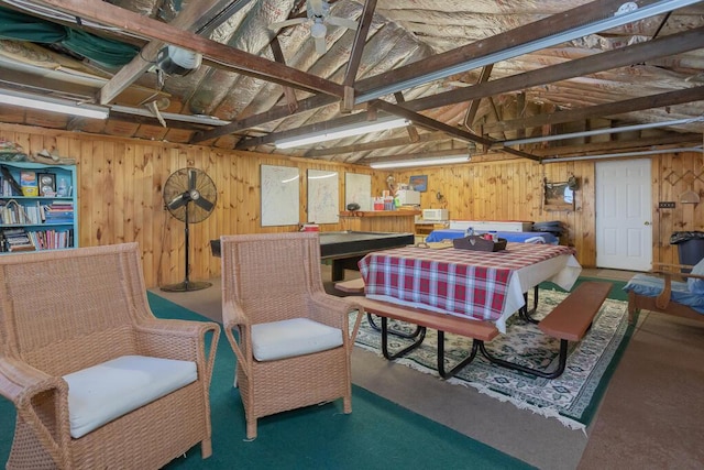 interior space featuring wooden walls, concrete flooring, and a workshop area