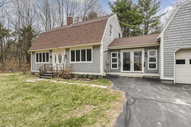 42 Ledge Hill Rd, Raymond, ME 04071 - view of front of property with a chimney, an attached garage, a shingled roof, and a gambrel roof
