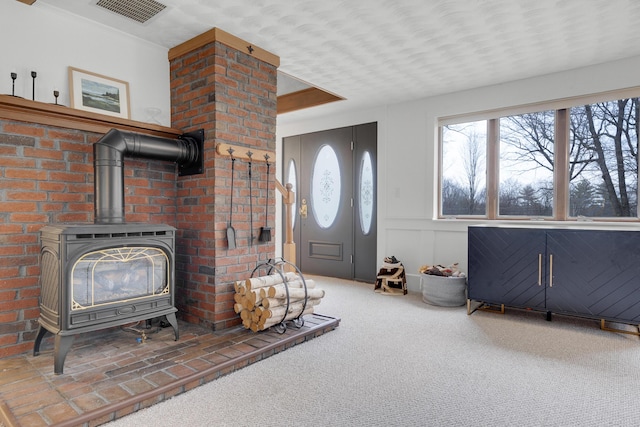 42 Ledge Hill Rd, Raymond, ME 04071 - carpeted living room with visible vents and a wood stove