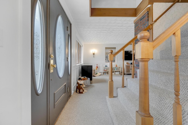 42 Ledge Hill Rd, Raymond, ME 04071 - carpeted foyer with stairs and wainscoting