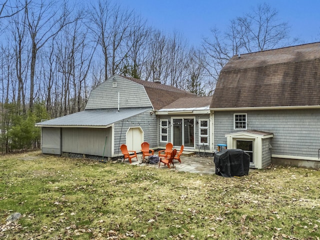 42 Ledge Hill Rd, Raymond, ME 04071 - rear view of house featuring a shingled roof, a gambrel roof, a patio, a yard, and a fire pit