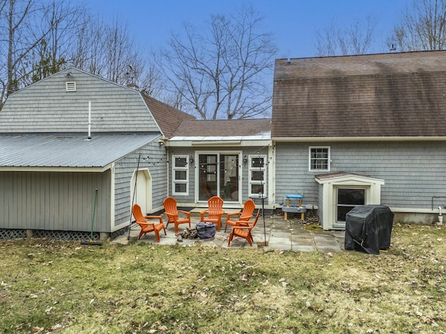 42 Ledge Hill Rd, Raymond, ME 04071 - back of property featuring roof with shingles, a lawn, an outdoor fire pit, a patio, and a gambrel roof