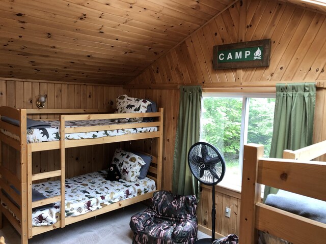 172 Alder Brook Ln, Waltham, ME 04605 - bedroom with lofted ceiling, wood walls, and wood ceiling