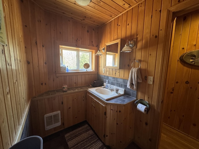 172 Alder Brook Ln, Waltham, ME 04605 - bathroom with vanity, wooden ceiling, wooden walls, and backsplash