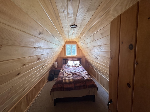 172 Alder Brook Ln, Waltham, ME 04605 - carpeted bedroom featuring wooden walls and lofted ceiling