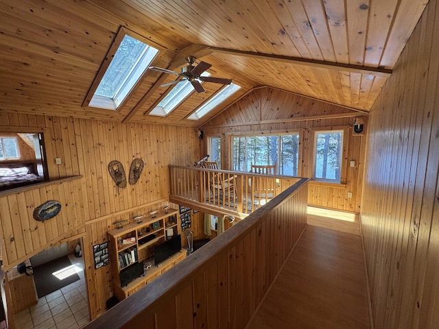 172 Alder Brook Ln, Waltham, ME 04605 - hall featuring wooden walls, lofted ceiling, a skylight, and wood ceiling
