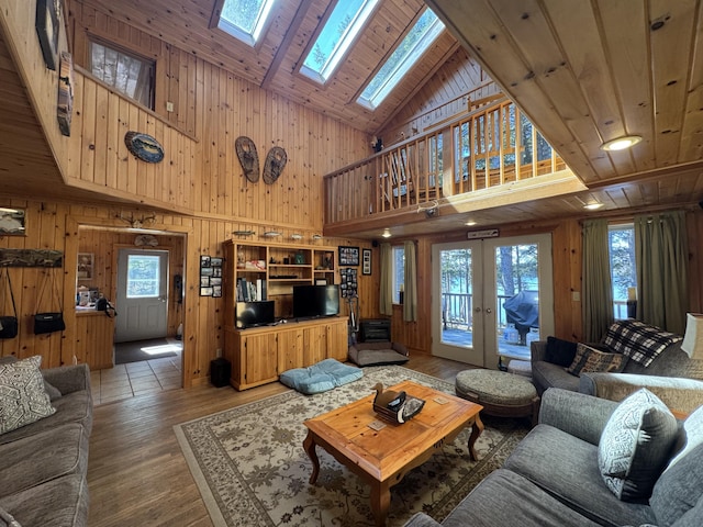 172 Alder Brook Ln, Waltham, ME 04605 - living room featuring high vaulted ceiling, plenty of natural light, a skylight, wood walls, and wood finished floors