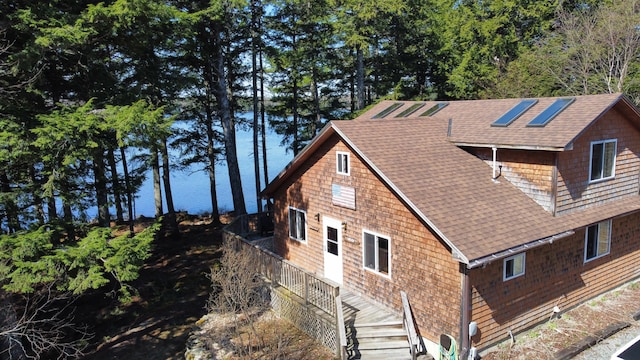 172 Alder Brook Ln, Waltham, ME 04605 - view of home's exterior with a shingled roof and a water view