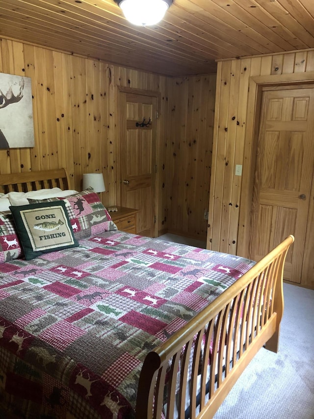 172 Alder Brook Ln, Waltham, ME 04605 - carpeted bedroom with wooden walls and wood ceiling