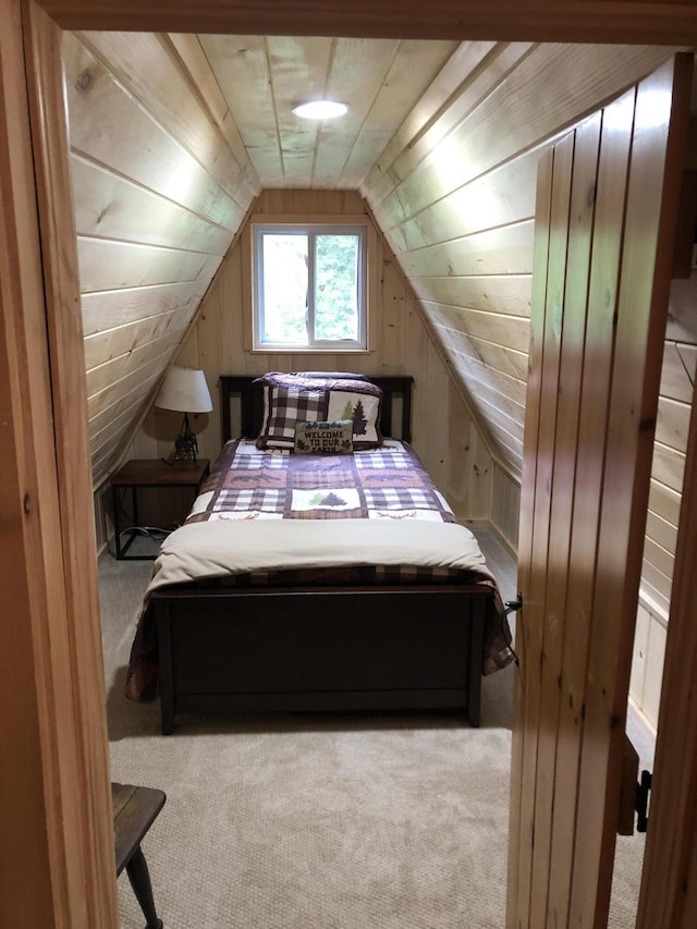 172 Alder Brook Ln, Waltham, ME 04605 - bedroom with carpet flooring, lofted ceiling, and wooden walls