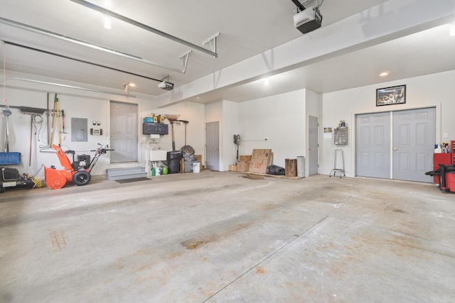 garage featuring a garage door opener and electric panel