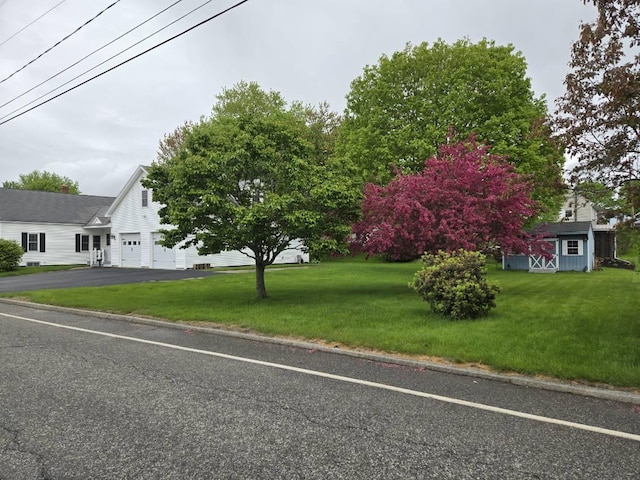 96 Rideout Ave, Lewiston, ME 04240 - obstructed view of property featuring asphalt driveway and a front yard