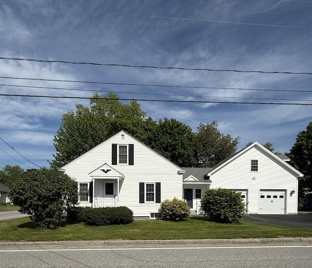 96 Rideout Ave, Lewiston, ME 04240 - view of front facade with driveway, a garage, and a front lawn