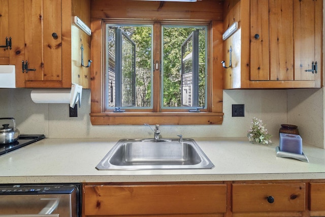507 State Route 32nd Rte, Bristol, ME 04554 - kitchen featuring stainless steel dishwasher, a sink, brown cabinetry, and light countertops