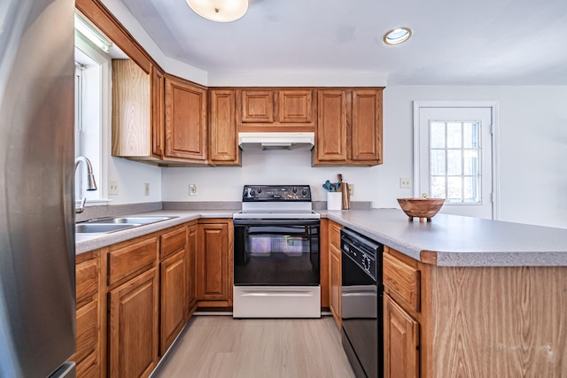 kitchen with electric range, dishwasher, freestanding refrigerator, a peninsula, and under cabinet range hood