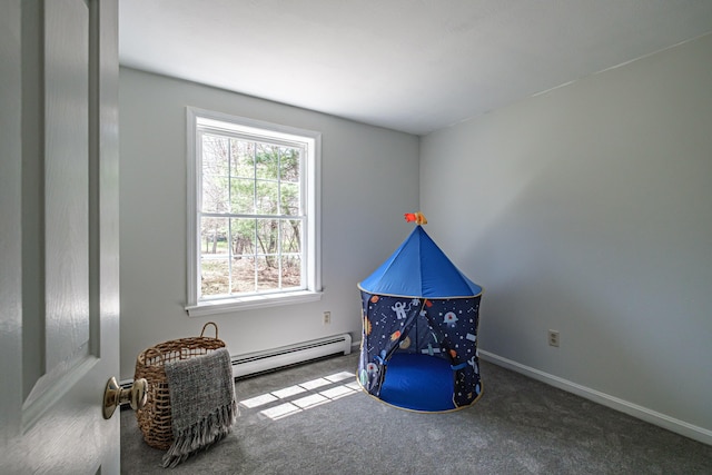recreation room with carpet floors, baseboards, and baseboard heating