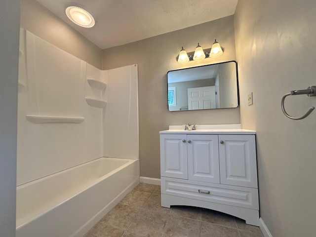 full bathroom featuring tile patterned flooring, baseboards, shower / washtub combination, and vanity