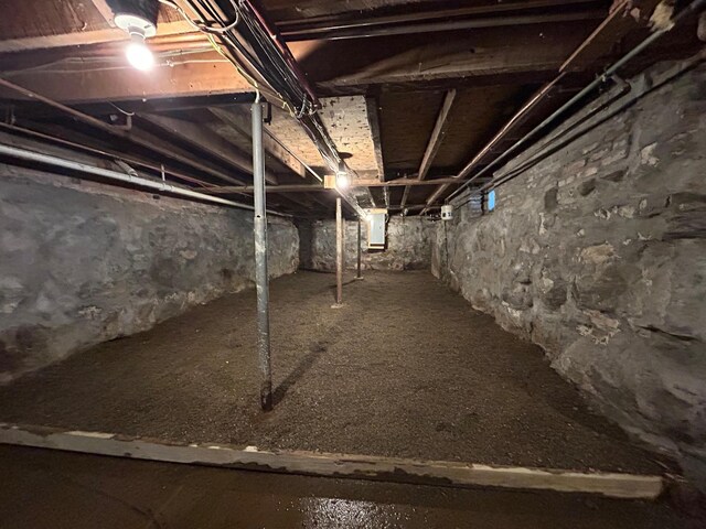 unfinished basement featuring electric panel