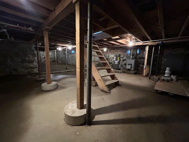 unfinished below grade area with stairway and water heater