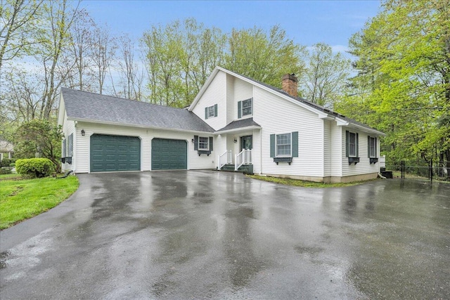 17 Fenton Way, Bangor, ME 04401 - view of front of home featuring a garage, a chimney, and driveway