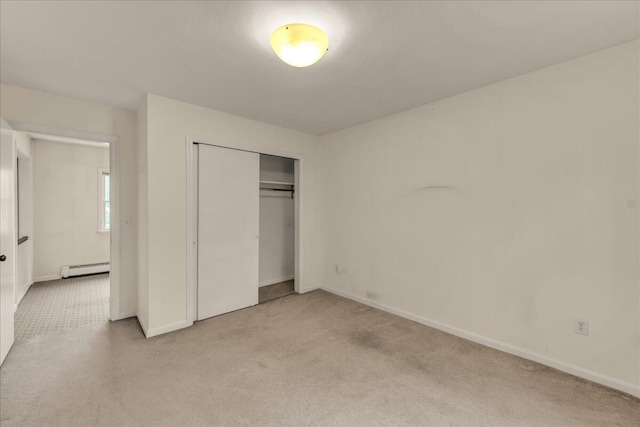 17 Fenton Way, Bangor, ME 04401 - unfurnished bedroom with light carpet, a closet, baseboards, and a baseboard radiator