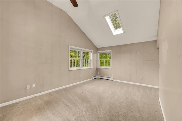 17 Fenton Way, Bangor, ME 04401 - carpeted empty room with a baseboard heating unit, a skylight, vaulted ceiling, baseboards, and a ceiling fan