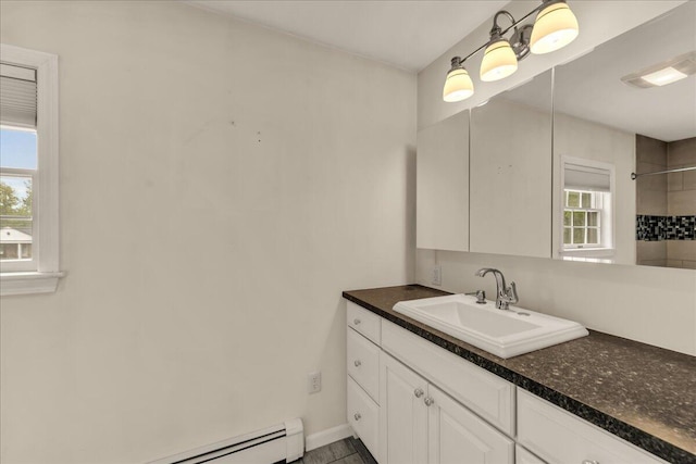 17 Fenton Way, Bangor, ME 04401 - bathroom featuring vanity, a tile shower, baseboard heating, and baseboards