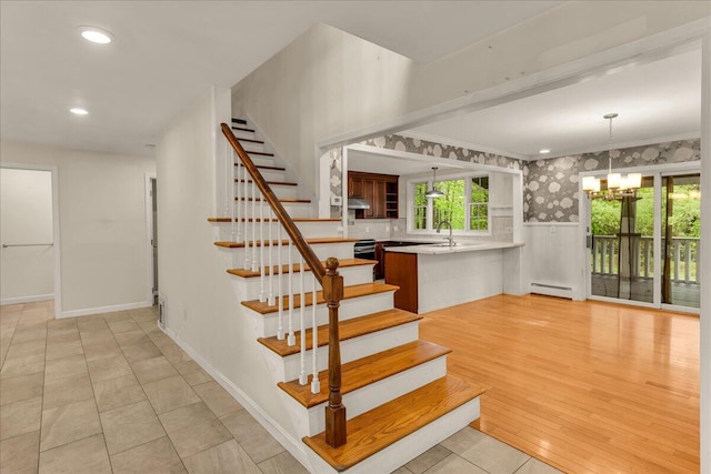 17 Fenton Way, Bangor, ME 04401 - stairs featuring a baseboard heating unit, a chandelier, wainscoting, crown molding, and recessed lighting