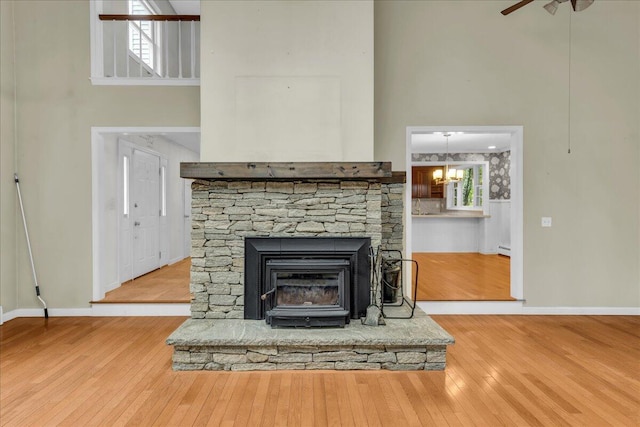 17 Fenton Way, Bangor, ME 04401 - detailed view of wood finished floors, a baseboard radiator, baseboards, ceiling fan, and a chandelier