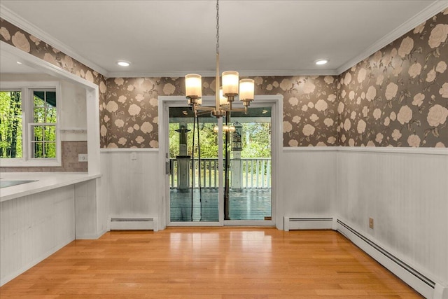 17 Fenton Way, Bangor, ME 04401 - unfurnished dining area featuring baseboard heating, a chandelier, a wainscoted wall, wood finished floors, and crown molding