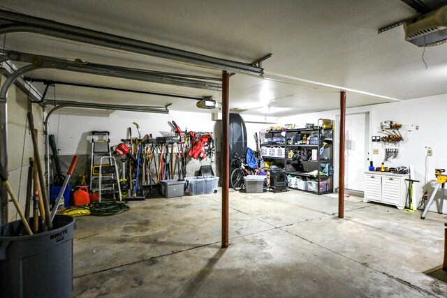 25 Ireland Dr, Berwick, ME 03901 - garage with a workshop area and a garage door opener