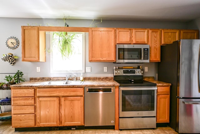 25 Ireland Dr, Berwick, ME 03901 - kitchen with appliances with stainless steel finishes, a sink, and light tile patterned floors