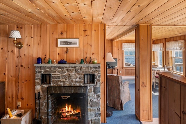 147 State Route 32, Bristol, ME 04554 - carpeted living area featuring wooden ceiling, wooden walls, and a stone fireplace